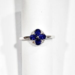18ct white gold four pear cut sapphire and four round brilliant cut diamond flower style ring